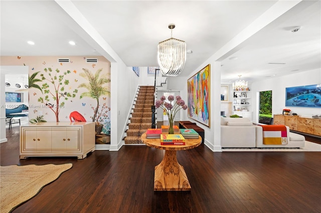 foyer entrance with wood-type flooring and a chandelier