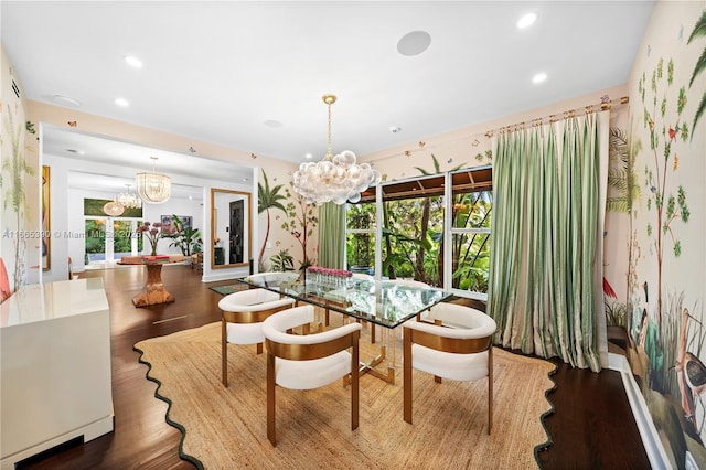 dining space with an inviting chandelier, wood finished floors, and a healthy amount of sunlight