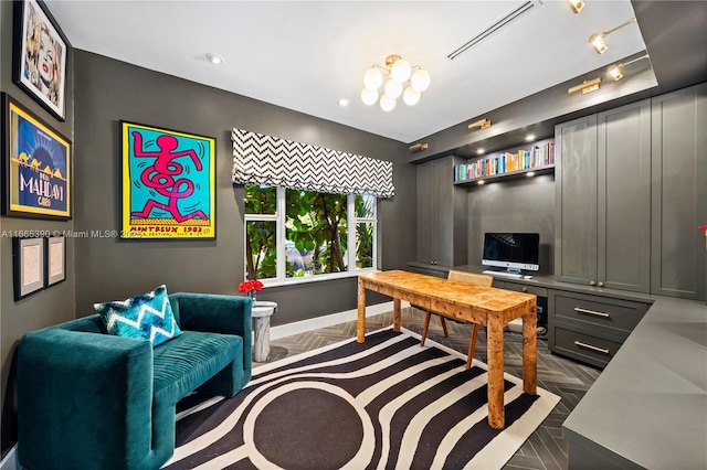 office area with rail lighting, baseboards, and visible vents