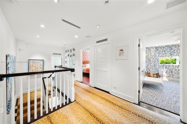 hall with an upstairs landing, visible vents, recessed lighting, and baseboards