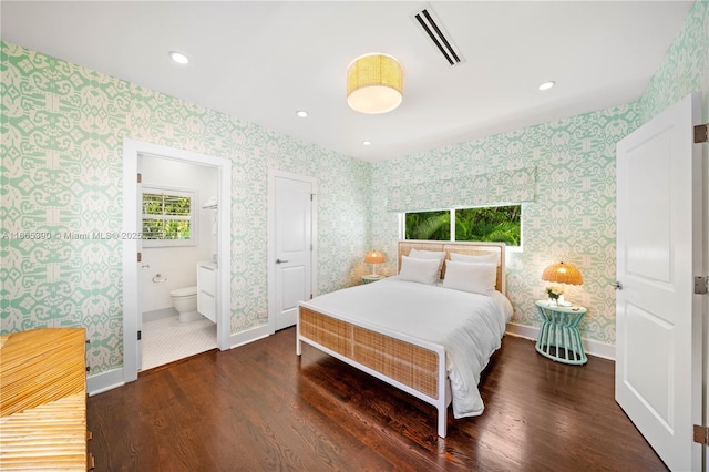 bedroom featuring visible vents, wallpapered walls, baseboards, and wood finished floors