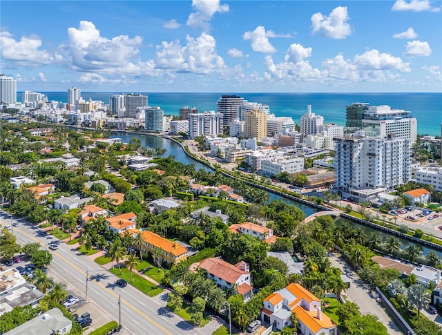 birds eye view of property featuring a water view and a city view