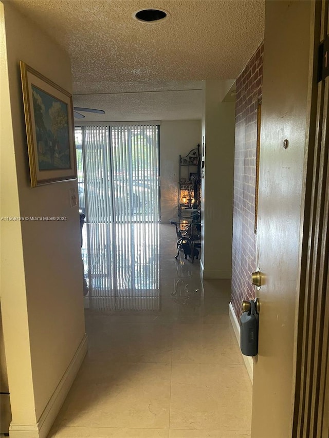 hallway with a textured ceiling