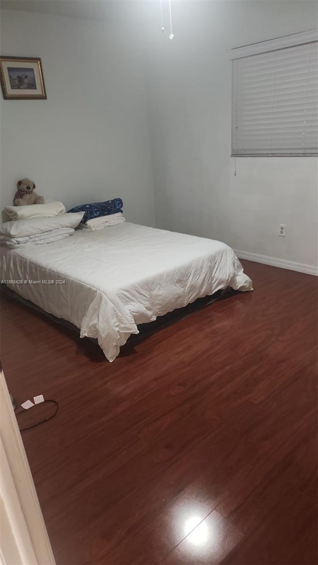 bedroom featuring dark wood-type flooring