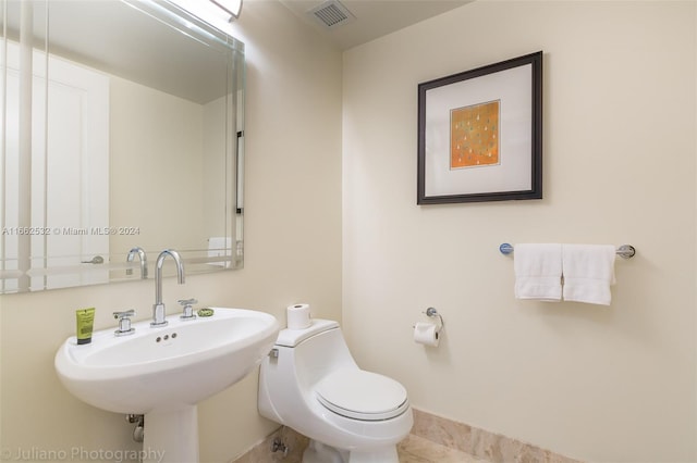 1435 Brickell Ave Unit 3603, Miami, FL 33131 - bathroom with a sink, toilet, and baseboards