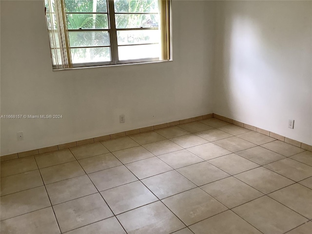 unfurnished room featuring light tile patterned floors