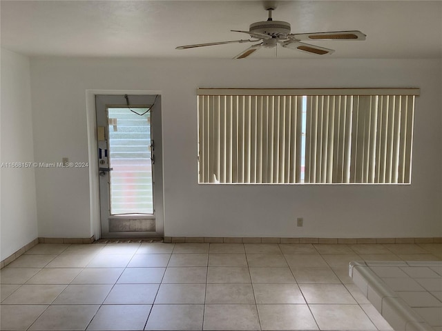 spare room featuring ceiling fan and light tile patterned flooring