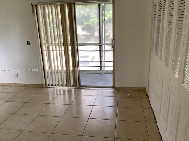 60 Windsor C Unit 60, West Palm Beach, FL 33417 - tiled empty room with baseboards and a wealth of natural light