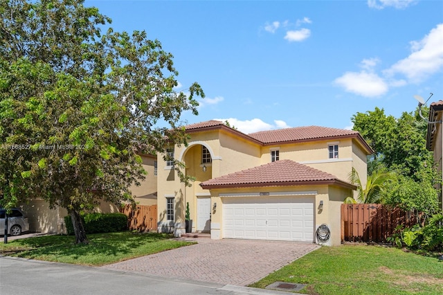 mediterranean / spanish-style home with a front yard