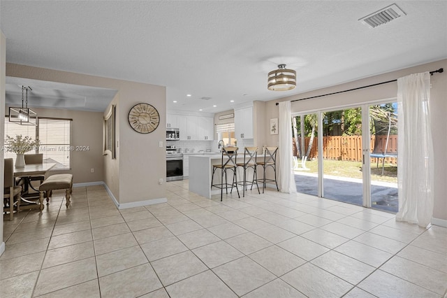 tiled spare room with a textured ceiling