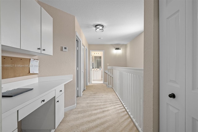 hallway with light colored carpet