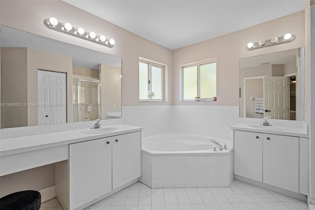 bathroom featuring tile patterned floors, independent shower and bath, and vanity