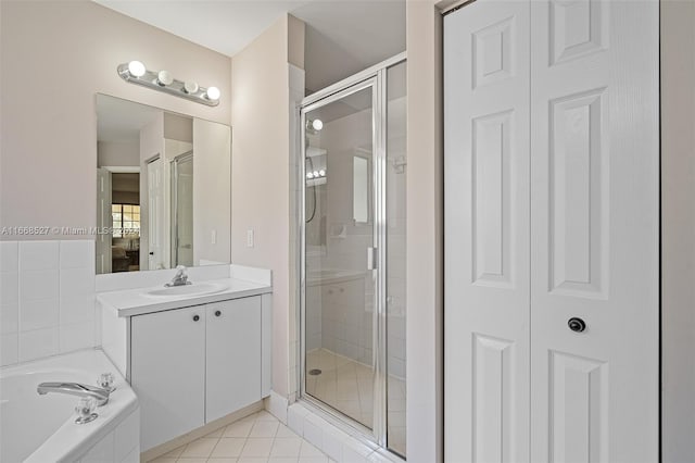 bathroom with tile patterned flooring, vanity, and separate shower and tub