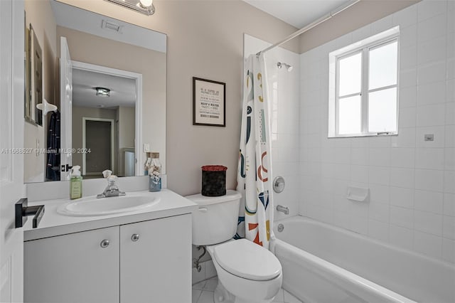 full bathroom with tile patterned flooring, vanity, toilet, and shower / bath combo with shower curtain