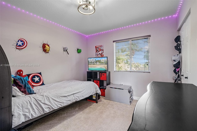 carpeted bedroom with a textured ceiling