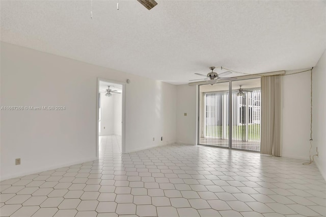 unfurnished room with light tile patterned flooring and a textured ceiling