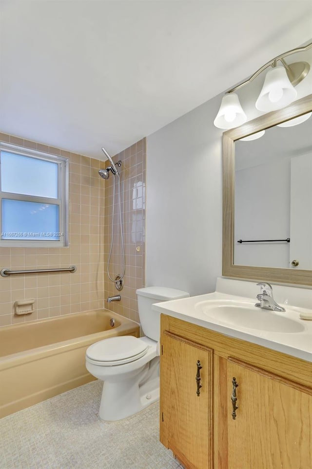 full bathroom with vanity, toilet, and tiled shower / bath