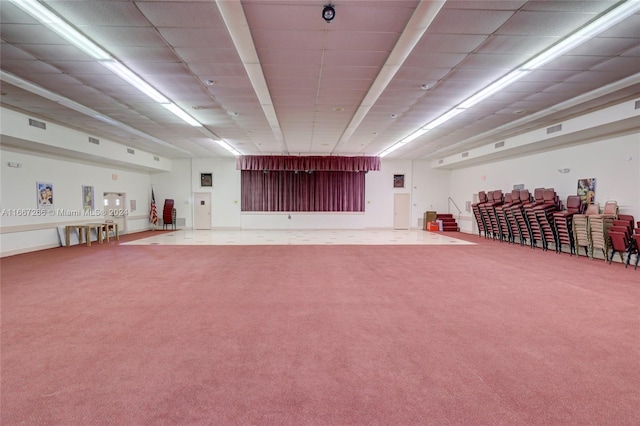 basement with carpet flooring and a paneled ceiling