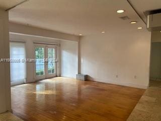 unfurnished room featuring french doors and wood-type flooring