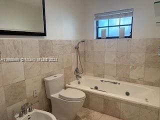 bathroom featuring toilet, tile walls, tiled shower / bath combo, a bidet, and tile patterned flooring