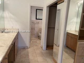 bathroom with vanity, tile walls, and tile patterned flooring