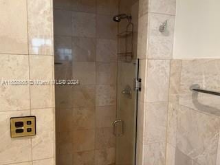 bathroom with a shower with shower door