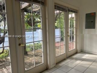 entryway featuring french doors, electric panel, and plenty of natural light