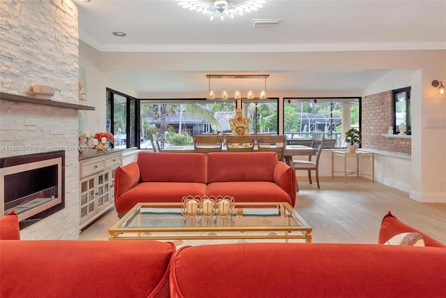 living room with light wood-type flooring, crown molding, and a stone fireplace