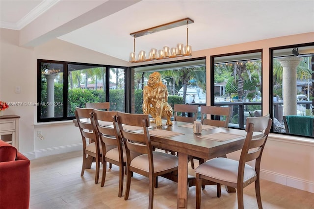 dining space featuring an inviting chandelier, lofted ceiling, light hardwood / wood-style flooring, and crown molding