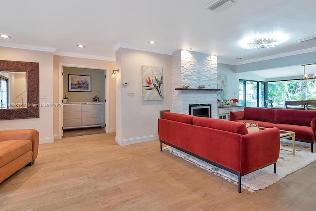 living room featuring light hardwood / wood-style floors, a stone fireplace, and ornamental molding