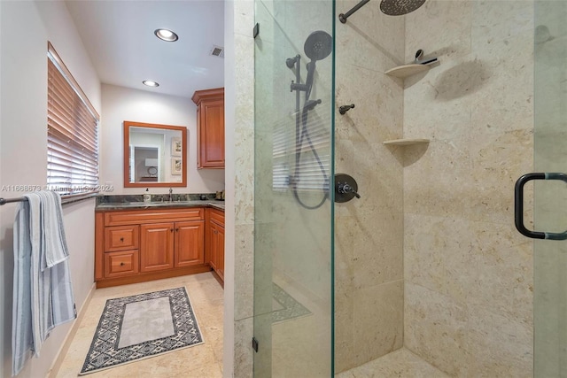 bathroom with tile patterned flooring, vanity, and a shower with shower door