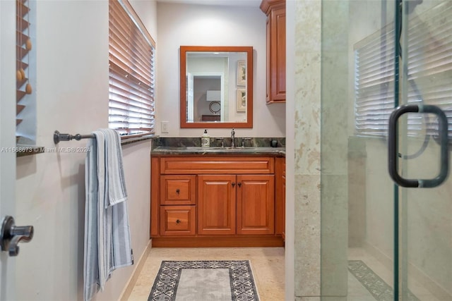 bathroom featuring vanity and a shower with door