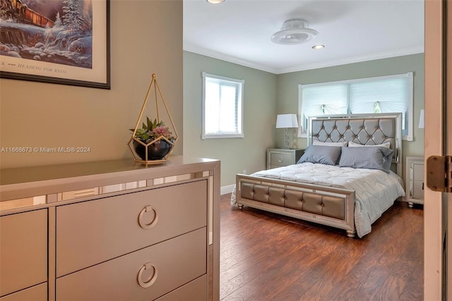 bedroom featuring ornamental molding and dark hardwood / wood-style flooring