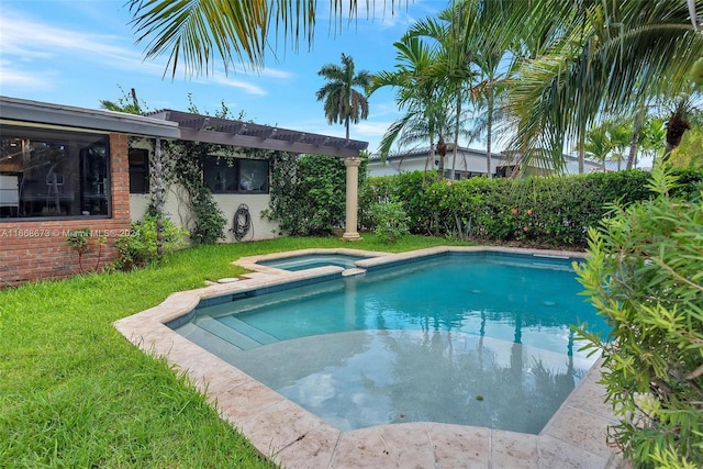 view of pool featuring an in ground hot tub and a yard