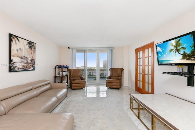 3800 S Ocean Dr Unit 811, Hollywood, FL 33019 - living area featuring light tile patterned flooring, french doors, and a wall of windows