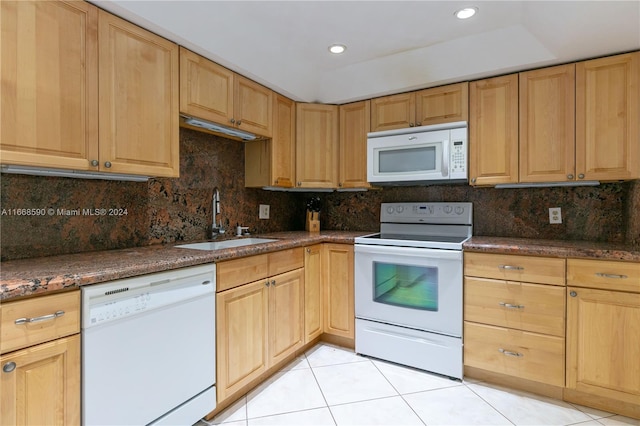 kitchen with light tile patterned flooring, backsplash, sink, and white appliances