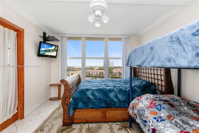 bedroom featuring light tile patterned floors, ornamental molding, and multiple windows