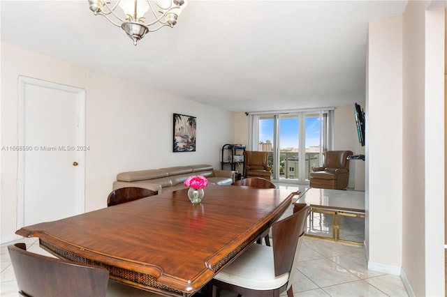 tiled dining area with a chandelier