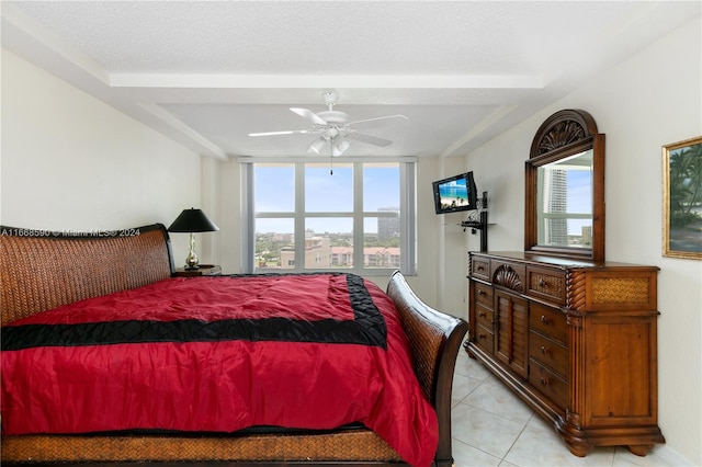 tiled bedroom featuring ceiling fan and a textured ceiling