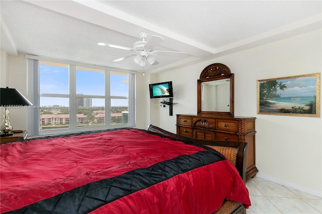 tiled bedroom featuring ceiling fan and a textured ceiling