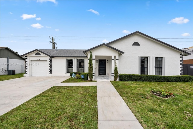 ranch-style home featuring central AC unit, a garage, and a front yard