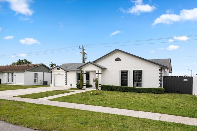 ranch-style house featuring a garage and a front lawn