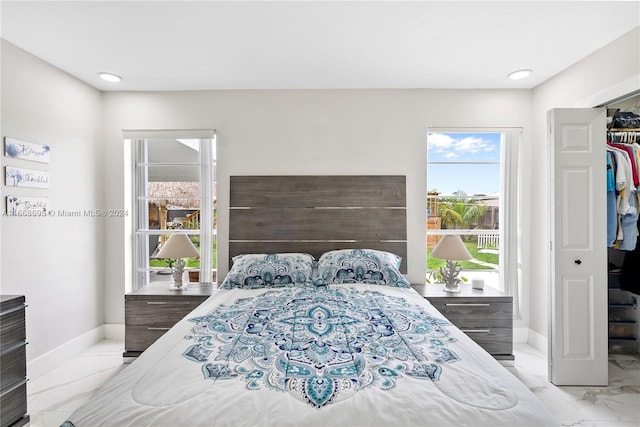 bedroom featuring a closet and multiple windows