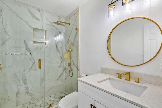 bathroom featuring vanity, toilet, and a shower with shower door