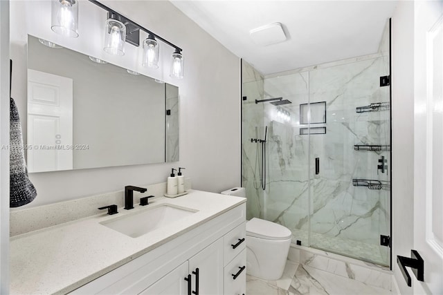 bathroom with vanity, toilet, and a shower with door