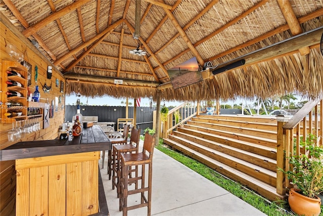 view of patio featuring a gazebo, a water view, and an outdoor bar