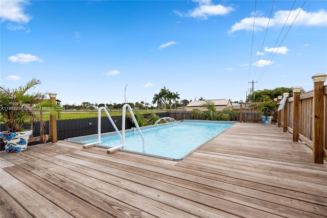 view of swimming pool with a wooden deck