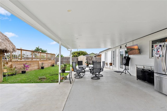 view of patio with a storage shed