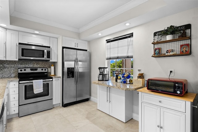 kitchen with white cabinetry, backsplash, light tile patterned floors, stainless steel appliances, and ornamental molding