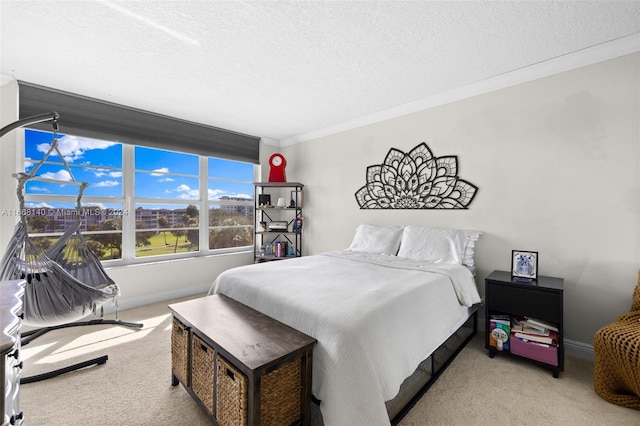 bedroom with light colored carpet, a textured ceiling, and ornamental molding